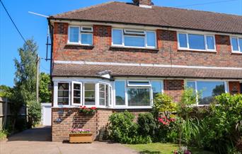 semi-detached house with driveway and small garden out the front