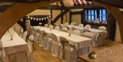 Image of decorated tables in the upper hall chamber of Bridge Cottage