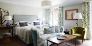 Double bedroom with couch and chair and small coffee table