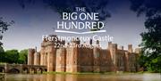 Herstmonceux Castle reflected in the moat, surrounded by greenery, with “The Big One Hundred – Herstmonceux Castle 22nd–23rd August” text overlaid.