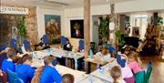 A room with children sitting round a table making art