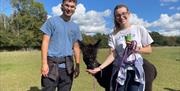 Two people holding a Alpaca
