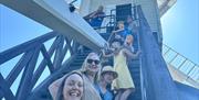 Image of family going up the steps to the windmill