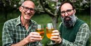 Image of two men cheering a pint of beer