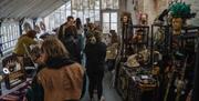 A room with people browsing folklore and antique products
