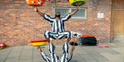 Two street performers performing a balancing act