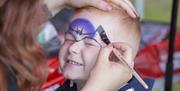A child getting their face painted