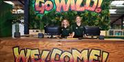Reception area at Go Wild! in Heathfield, featuring a jungle-themed welcome desk and staff ready to greet visitors.