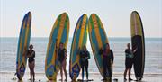 ladies with surfboards on beach