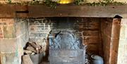 Image of the fire place in the main hall of Bridge Cottage