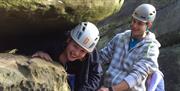 People coming out from under rock at Nuts4 Climbing