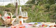 picnic table full of snacks and there wine made at the vineyard