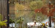 Exterior image of the accommodation and jacuzzi at the Secret Vineyard over looking a pond