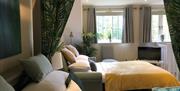 A double bed and sofa bed with TV