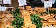 an array of pastries including sausage rolls and cheese strings