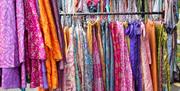 Two rails of colourful clothing