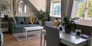 living and dining room area with sofa bed and table and chairs
