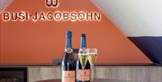 Two bottles and glasses of Busi Jacobsohn wine