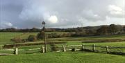 green fields surrounding barn