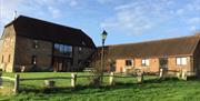 converted 1824 barn surrounded by green grass