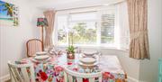 dining area with table and chairs, and large bay window