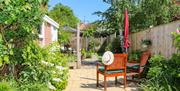 back garden with chairs and parasol