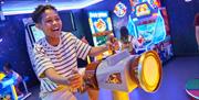 Image of a boy playing on the arcade games at Drusillas Park