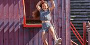 A image of a girl on a zip line at Drusillas Park