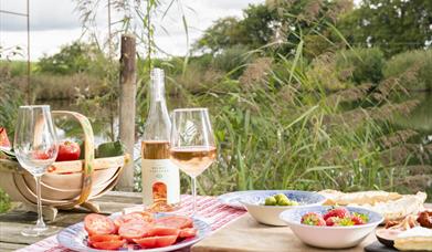 picnic table full of snacks and there wine made at the vineyard