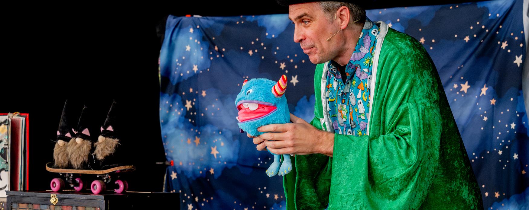 A magician speaking on a stage