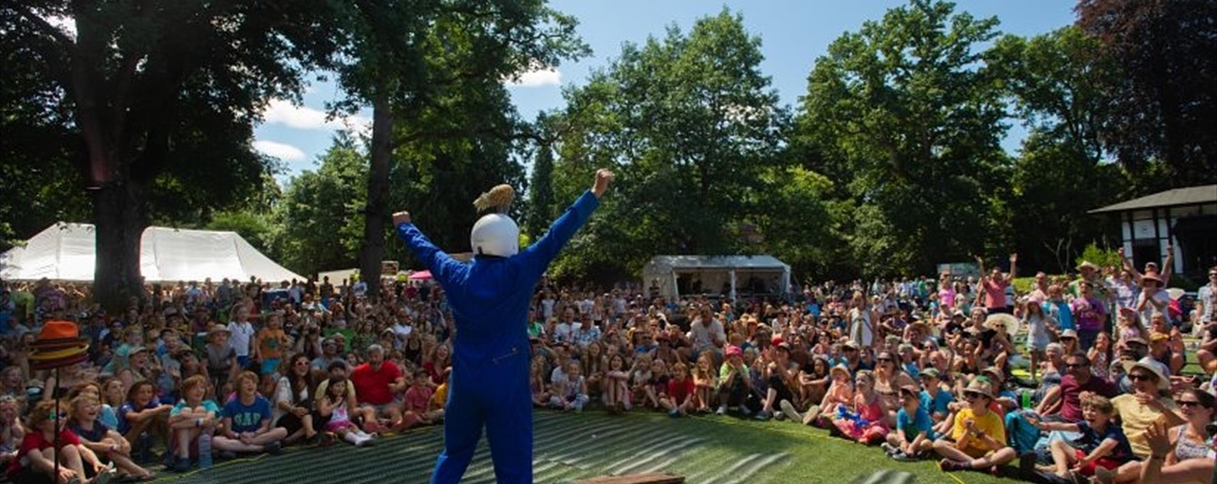 A performer, talking to an audience outside