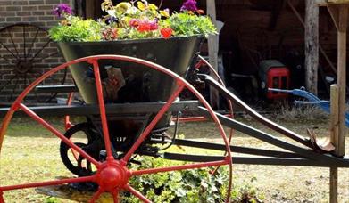 Flowers in old farm machinery from Horam Manor