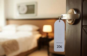 Hotel room with key in door