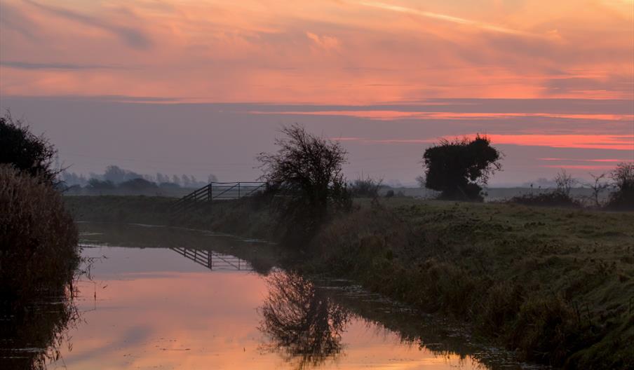 pink skies over a river of water