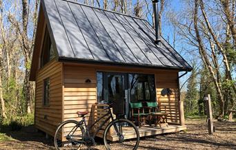 Alfriston Wood Cabins exterior shot with bike