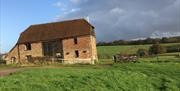 back of barn with surrounding green fields