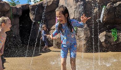 image of a girl playing in the jungle splash