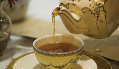 Photo of a teapot pouring tea