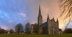 Setting sun behind salisbury cathedral