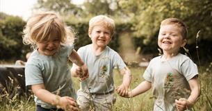 Children playing in grass fields