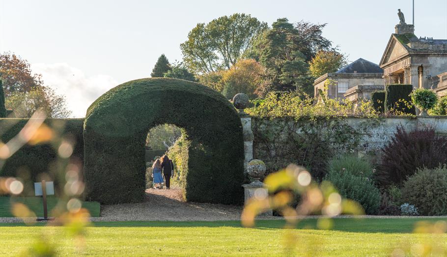 People walking amongst formal garden