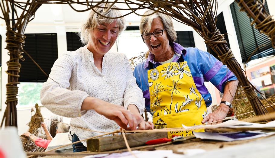 Women creating a craft from willow