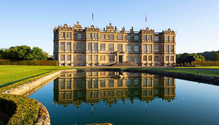 view of Longleat House, with reflection in fountain