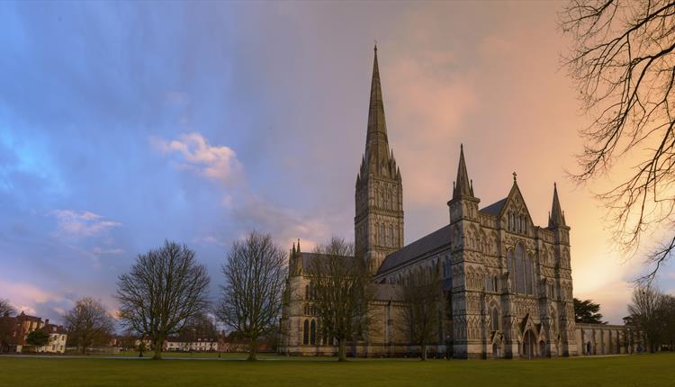 Setting sun behind salisbury cathedral