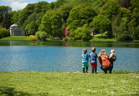 A family looking out over the lake and Pantheon in the distance at Stourhead