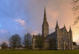 Setting sun behind salisbury cathedral