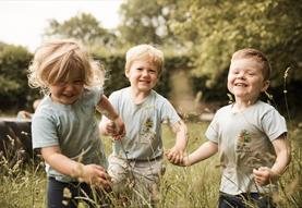 Children playing in grass fields