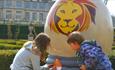 2 children staring at a giant Easter egg