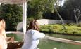 Two women looking across side of boat at gorilla colony