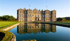 view of Longleat House, with reflection in fountain